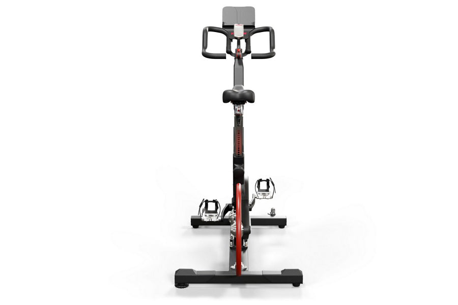 Keiser M3i stationary indoor cycle with black frame, red accents, digital display console, and foot pedals on white backgroun