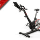 Black and red indoor exercise bike with upright frame, adjustable seat and handlebars, red flywheel, on white background