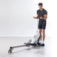 Man using black Kettler Coach E rowing machine on white background, wearing dark t-shirt and shorts
