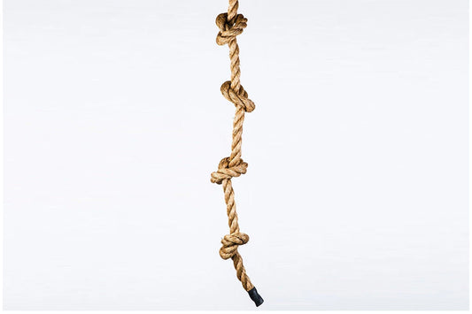 Knotted climbing rope in natural manila with evenly spaced knots, on white background