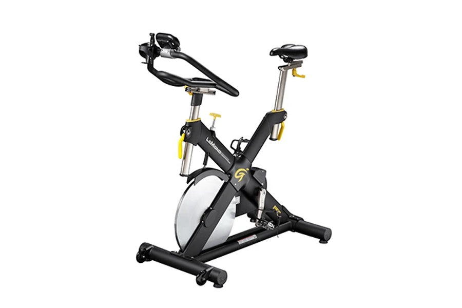 Black and yellow stationary indoor cycling bike with white wheel, padded seat, and adjustable handlebars on white background