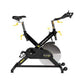 Black and yellow indoor exercise bike with drop handlebars, adjustable seat, and large flywheel, front view on white backgrou