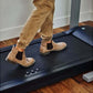 Tan suede Chelsea boots worn by model on black treadmill desk with camel joggers