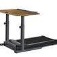Adjustable treadmill desk with walnut wood top, dark gray metal frame, and built-in black treadmill, shown on white backgroun