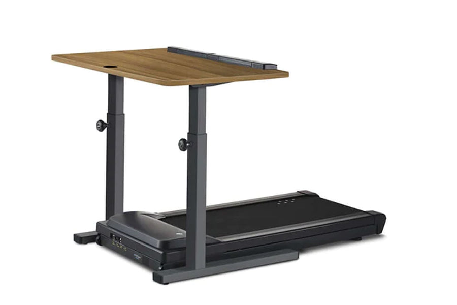 Adjustable treadmill desk with walnut wood top, dark gray metal frame, and built-in black treadmill, shown on white backgroun