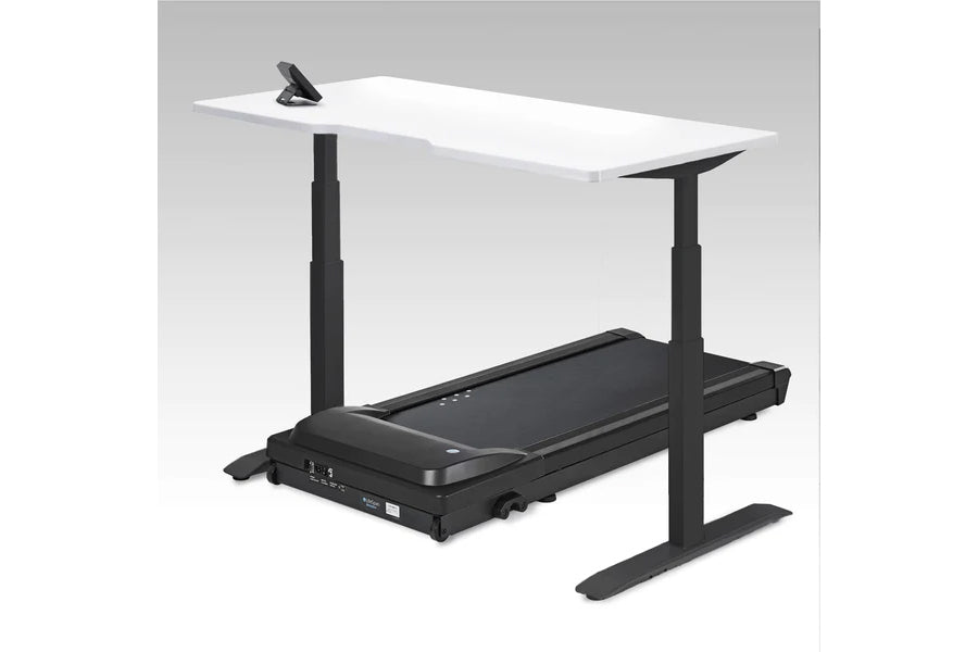 White desktop on black adjustable base with integrated treadmill underneath, shown on gray background