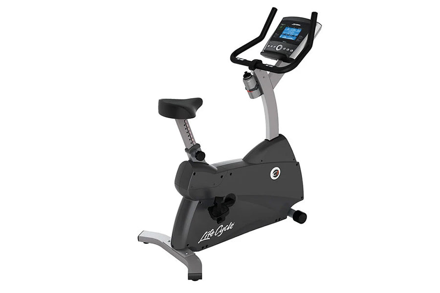 Black and gray upright exercise bike with digital console, black padded seat, and gray frame on white background
