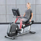 Woman in gray t-shirt and pink leggings seated on Life Fitness recumbent exercise bike with digital display, silver frame, an