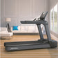 Life Fitness Club Series Plus treadmill with dark gray frame and digital display, positioned in modern living room with white