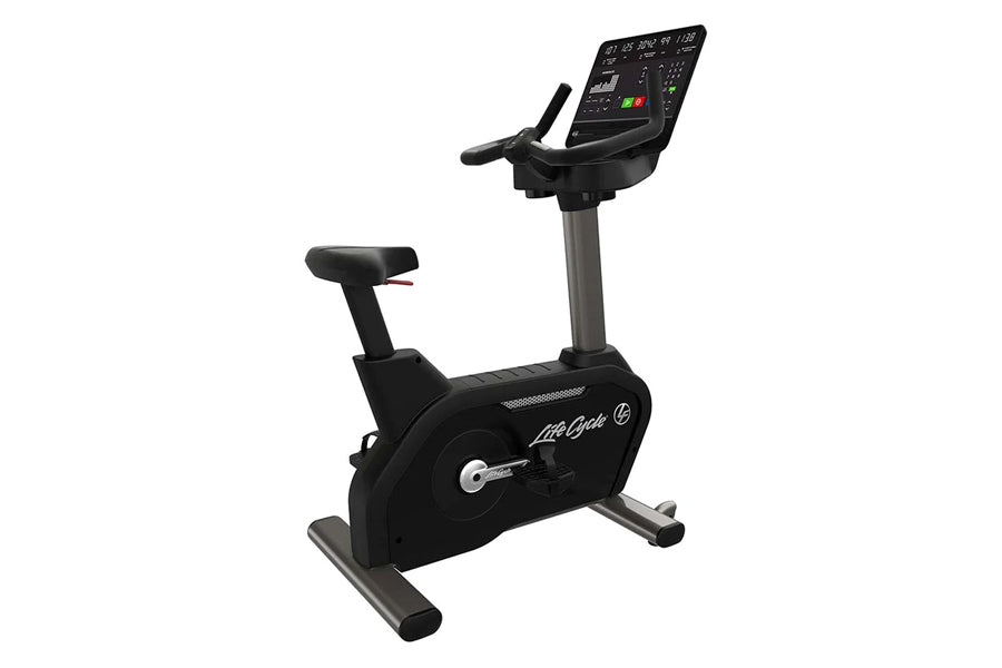 Black Life Fitness upright exercise bike with digital display console, handlebars, and foot pedals on white background