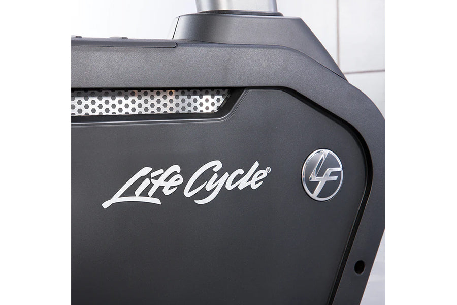 Black upright stationary bike with perforated metal panel, Life Cycle branding, and digital console display