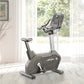 Upright stationary exercise bike with black and gray frame, digital console display, and padded seat in bright room with wind