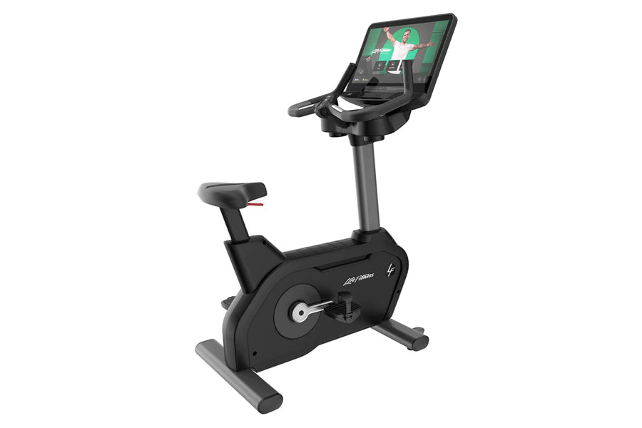 Black upright exercise bike with gray base, adjustable seat, and digital touchscreen display mounted on vertical console show