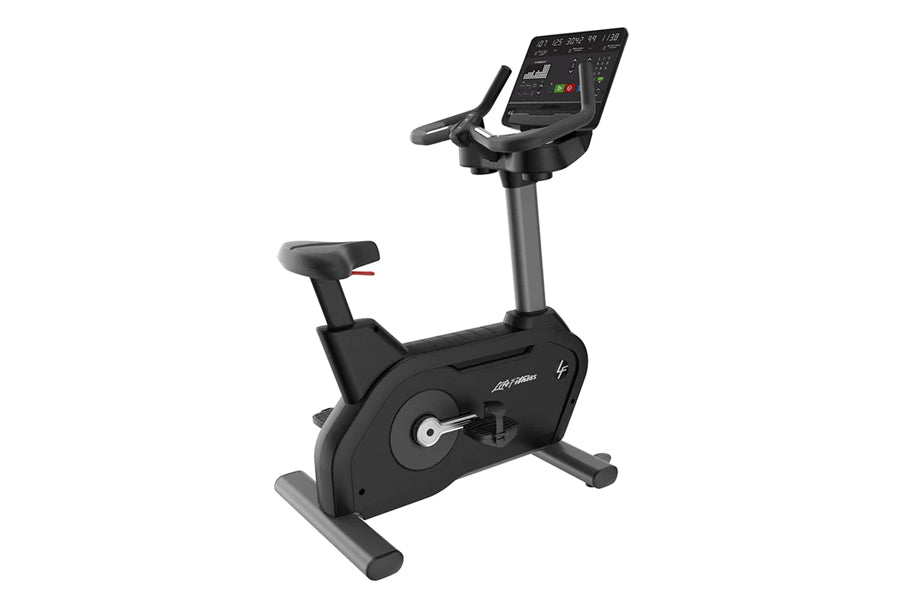 Black upright stationary exercise bike with digital console display, adjustable seat, and gray base on white background