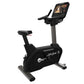 Black Life Fitness upright exercise bike with digital display console, stationary pedals, and gray base on white background