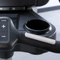 Black and silver upright exercise bike control panel with level adjustment buttons and white grip handle, close-up view