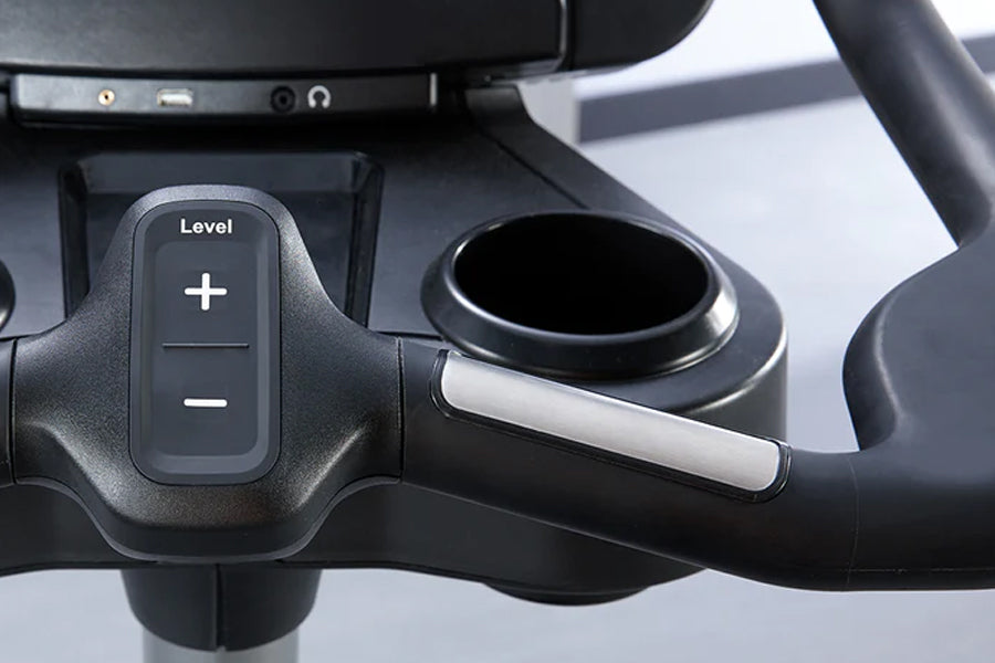 Black upright stationary bike controls showing level adjustment buttons with plus and minus symbols and silver handlebar grip