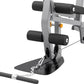 Gray and black home gym equipment with padded leg extension attachment, footplate, and dual handle bars on white background