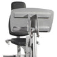 Stationary exercise bike with black padded seat and backrest, silver frame, and dual storage compartments mounted above, on w
