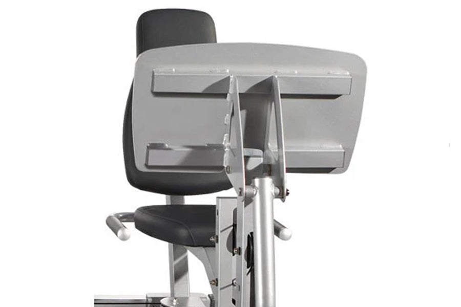 Stationary exercise bike with black padded seat and backrest, silver frame, and dual storage compartments mounted above, on w