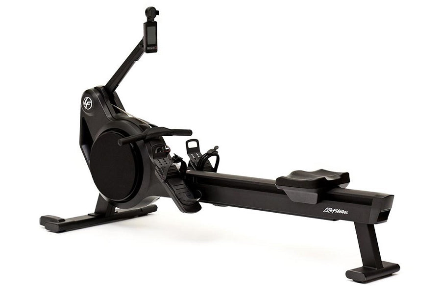 Black rowing machine with digital monitor, adjustable foot pedals, and extended sliding seat on white background