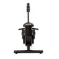 Black stationary rowing machine with vertical monitor arm, dual foot pedals, and horizontal footrest on white background