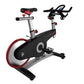 Life Fitness LifeCycle GX stationary bike with black frame, red wheel trim, silver handlebars, and red padded seat on white b