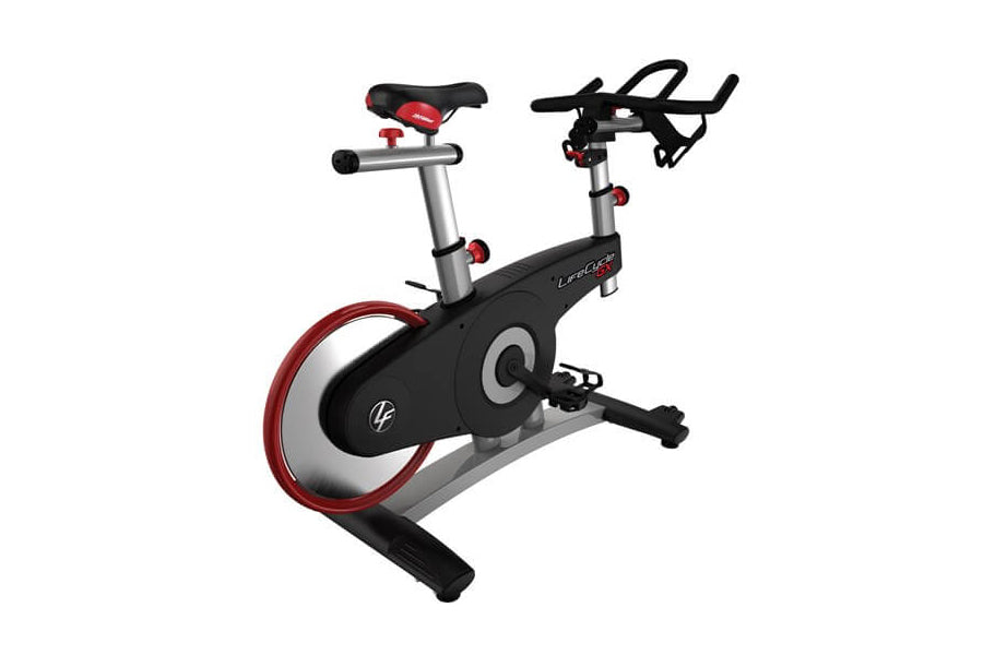 Indoor exercise bike with black and silver frame, red accented wheel, black seat, and handlebar display, shown at angle on wh