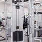 White and black Cybex strength training machines with adjustable pulleys in a modern gym setting