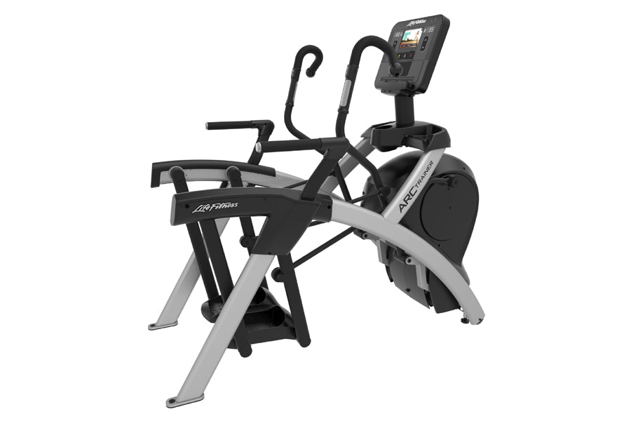 Life Fitness arc trainer with black and silver frame, curved handles, footplates, and digital console on white background