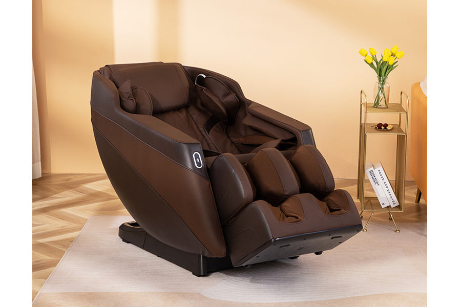 Brown leather zero gravity massage chair with leg rest extended, displayed in a home setting with wood flooring and gold acce