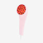 Pink handheld LED light therapy device with red and amber illuminated bulbs on circular head, white cord, on white background