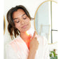 Woman using red LED light therapy device on neck, demonstrating wrinkle treatment use