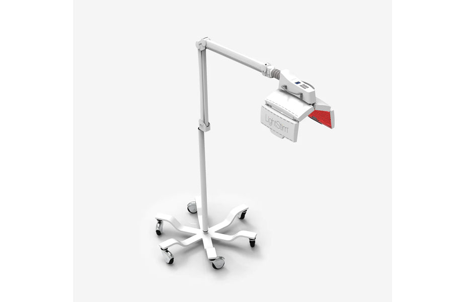 White adjustable LED light therapy lamp with articulating arm, red filter panel, and wheeled base on white background
