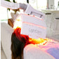 LightStim ProPanel LED light therapy lamp with red and yellow light therapy beams on model's hair and shoulder