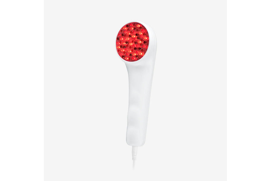 White handheld LED light therapy device with red light head on neutral background