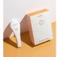 White handheld LightStim LED light therapy device next to product box on yellow background