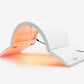 Red light therapy lamp with gray and white base, emitting orange glow, on white background