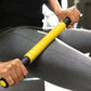Person using yellow and black massage roller on gray leggings during workout