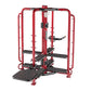 Red and black multi-station gym equipment with safety cage frame, adjustable weight arms, and textured black footplate on whi