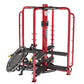 Red and black commercial multi-functional gym equipment machine with cable pulley system and leg press attachment on white ba