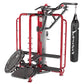 Red and black multi-functional home gym cage with pull-up bar, adjustable arm machine, heavy bag attachment, and tire wheel o