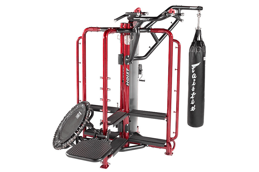 Red and black multi-functional home gym cage with pull-up bar, adjustable arm machine, heavy bag attachment, and tire wheel o