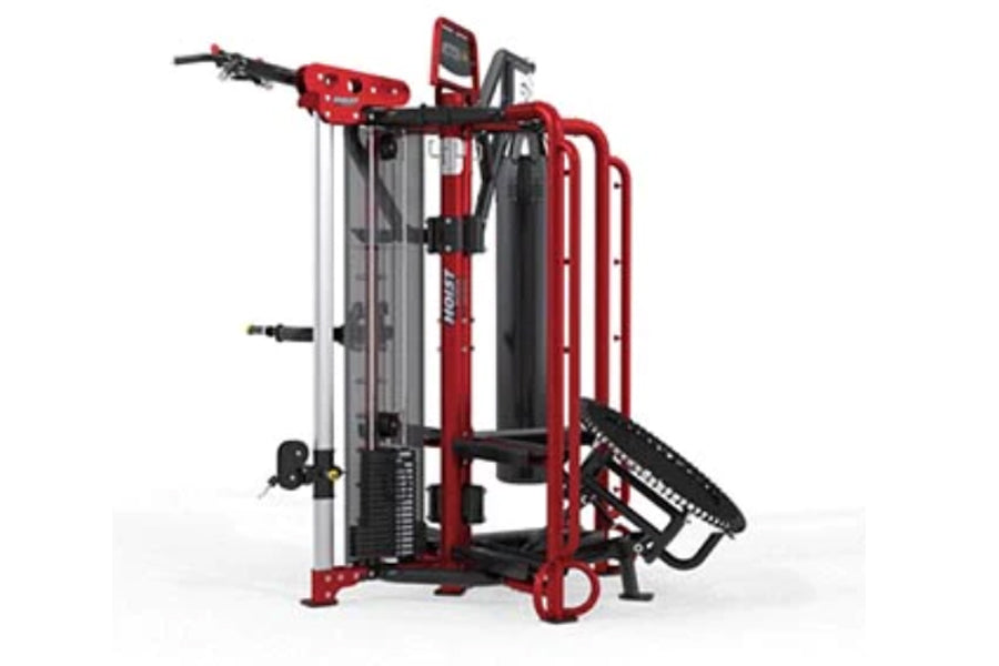 Red and black multi-station gym equipment with digital display, featuring leg press, chest press, and cable machines on white