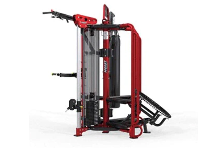 Red and black multi-station gym equipment with cable machines, leg press, and lat pulldown attachments on white background
