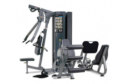 Multi-station exercise machine with gray metal frame, black padding, digital display panel, and various weighted resistance a