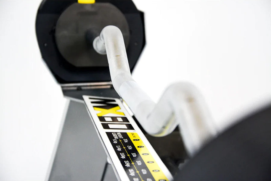 White rapid-change collar mechanism on black and yellow adjustable barbell system with weight adjustment dial visible