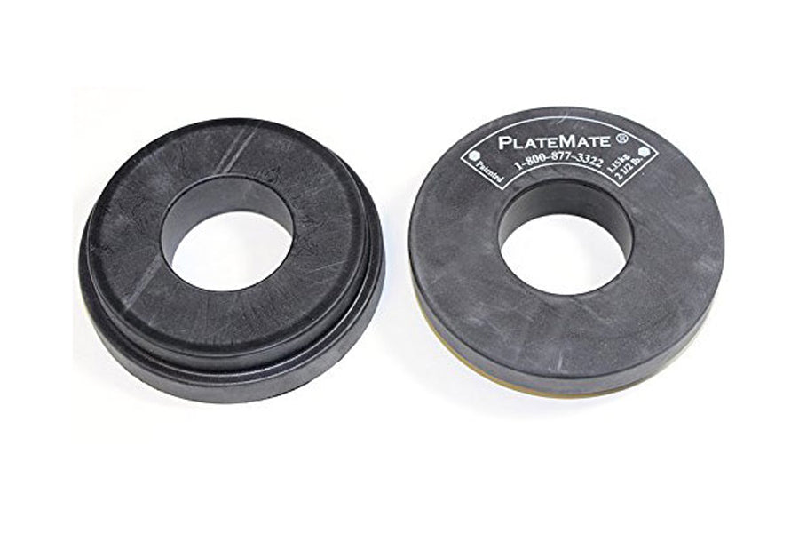 Pair of dark gray circular magnetic doughnut add-on plates with center holes, flat lay on white background