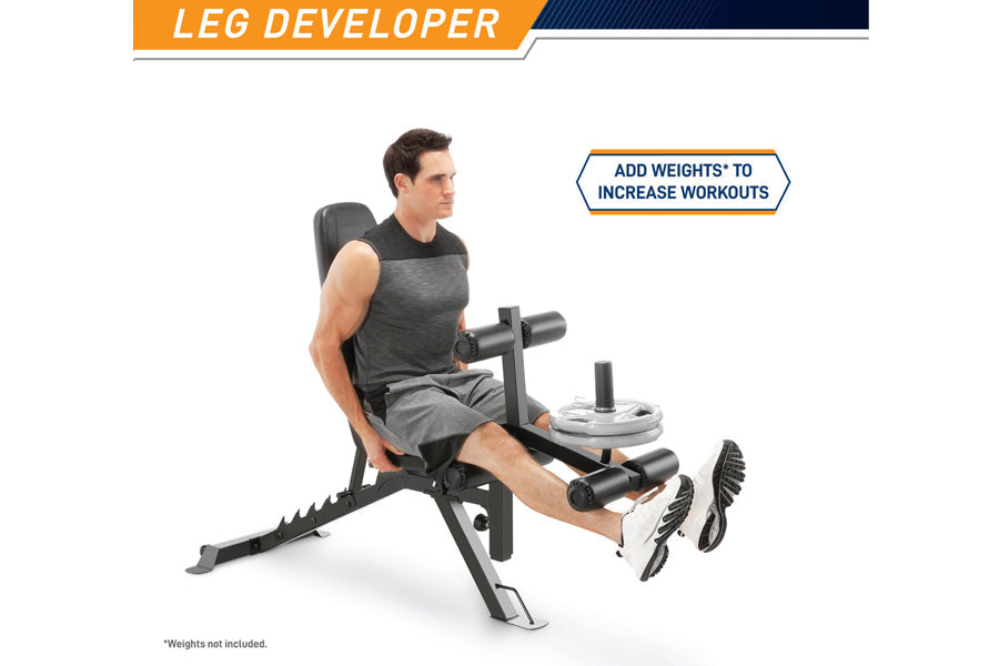 Man using black Marcy leg developer weight bench with padded seat and adjustable leg extension, weights not included