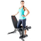 Woman wearing turquoise tank top and navy capri leggings posing next to black Marcy Deluxe Utility Weight Bench with red logo